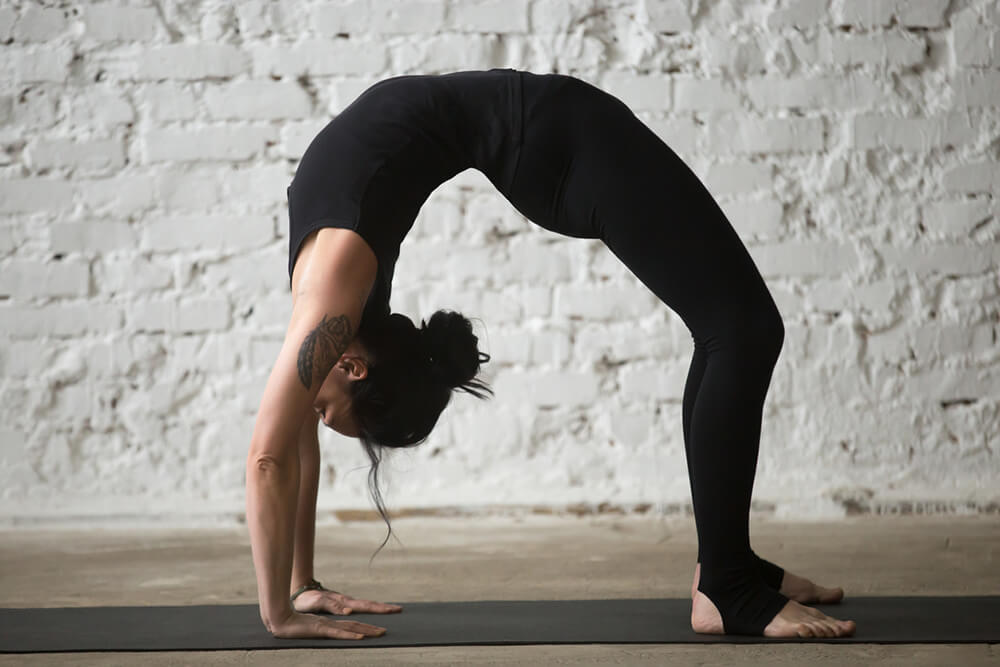 Wheel Pose (Urdhva Dhanurasana) – Queen of Yoga Backbends - TINT Yoga